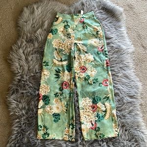 Green trousers with flower pattern
